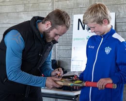 Junior club member Riley proud to get his bat signed by Kane Williamson.